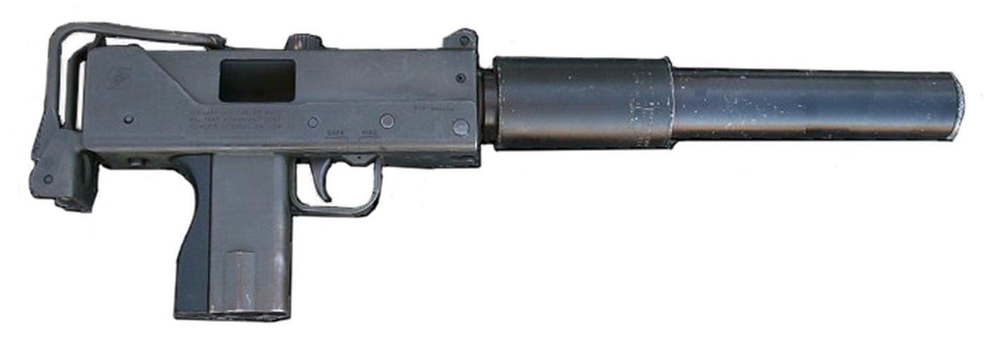 An original Ingram MAC-10 submachine gun with its folded wire stock and a long two-stage suppressor on the muzzle