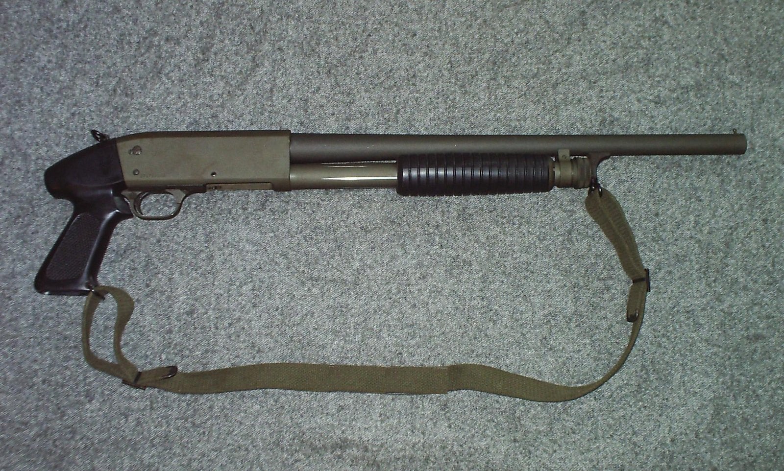 Parkerized Ithaca Model 37 riot shotgun with pistol grip stock and web sling