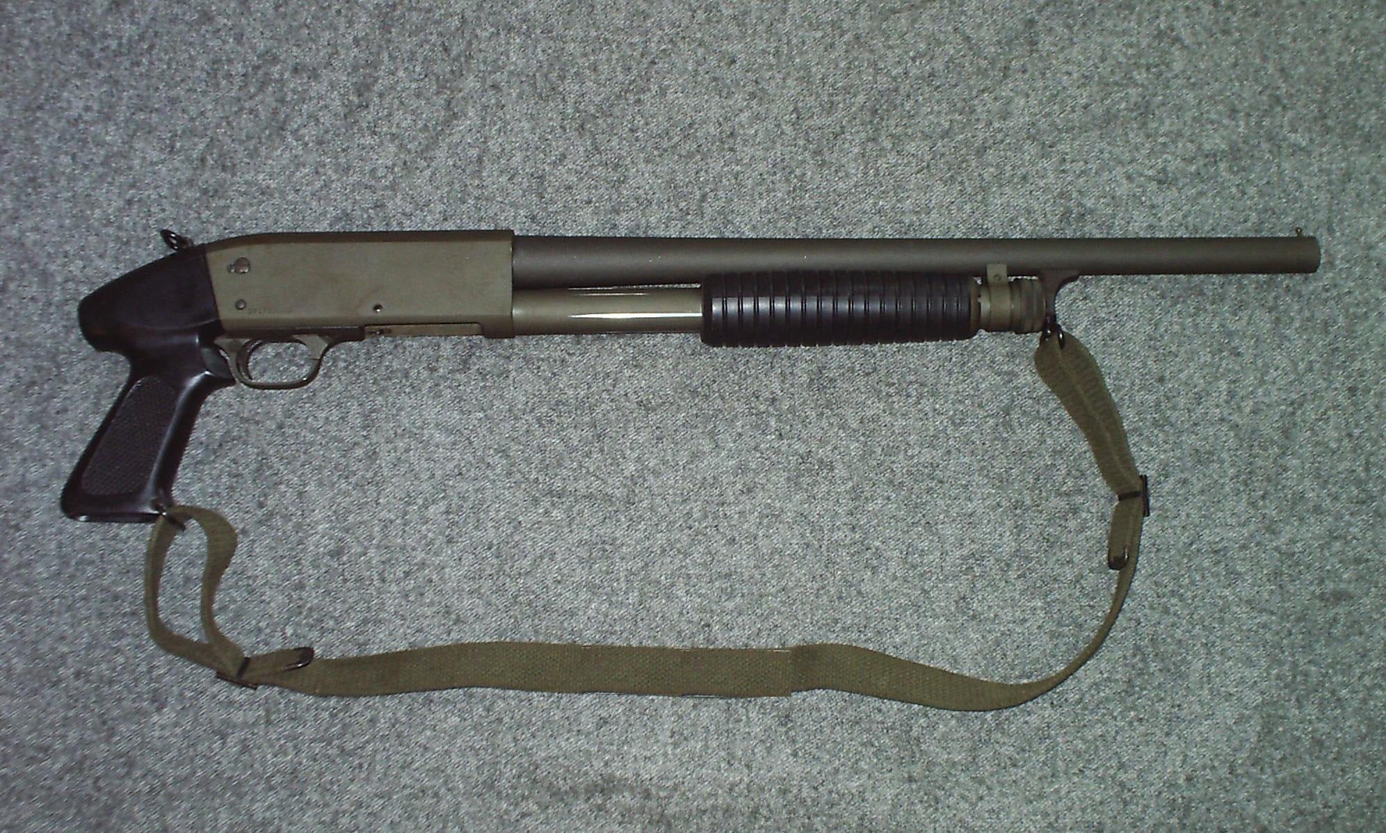 Parkerized Ithaca Model 37 riot shotgun with pistol grip stock and web sling
