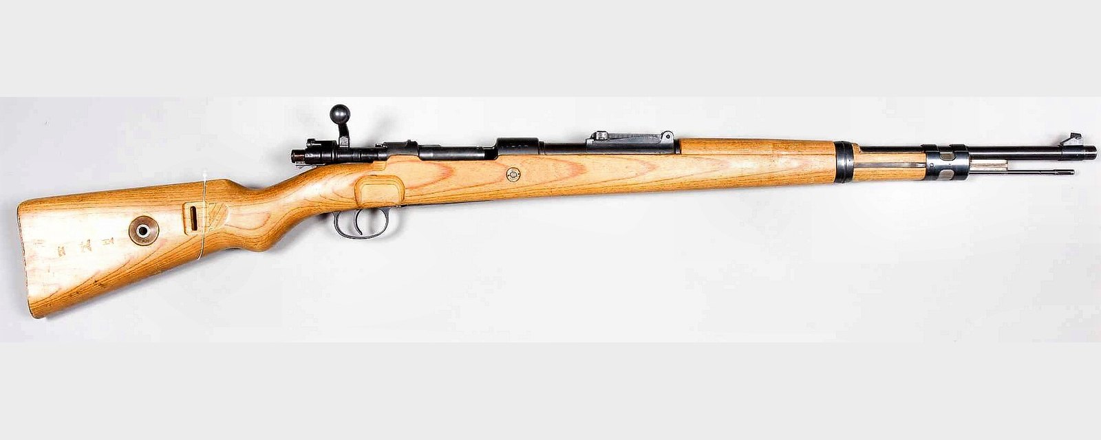 Right side of a 1940 German Karabiner 98k Mauser rifle showing the turned-down bolt handle, stock disk and sling slot