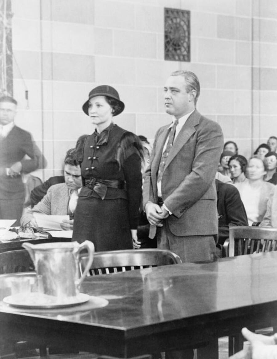 Kathryn and George Machine Gun Kelly standing in an Oklahoma City courtroom as they are sentenced to life in prison in October 1933