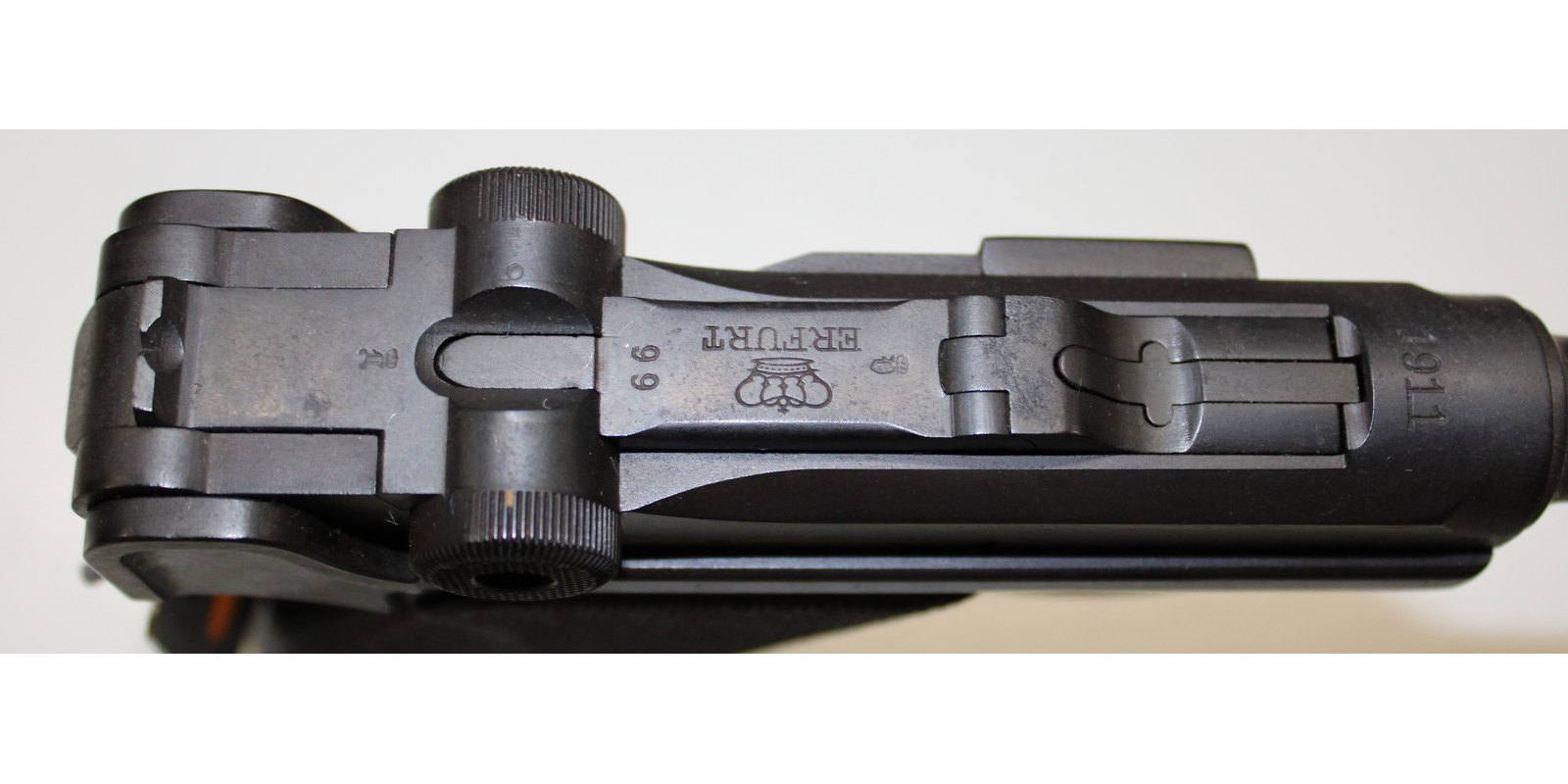 Top view of a 1911 Erfurt Luger showing the crown over ERFURT toggle marking and 1911 chamber date