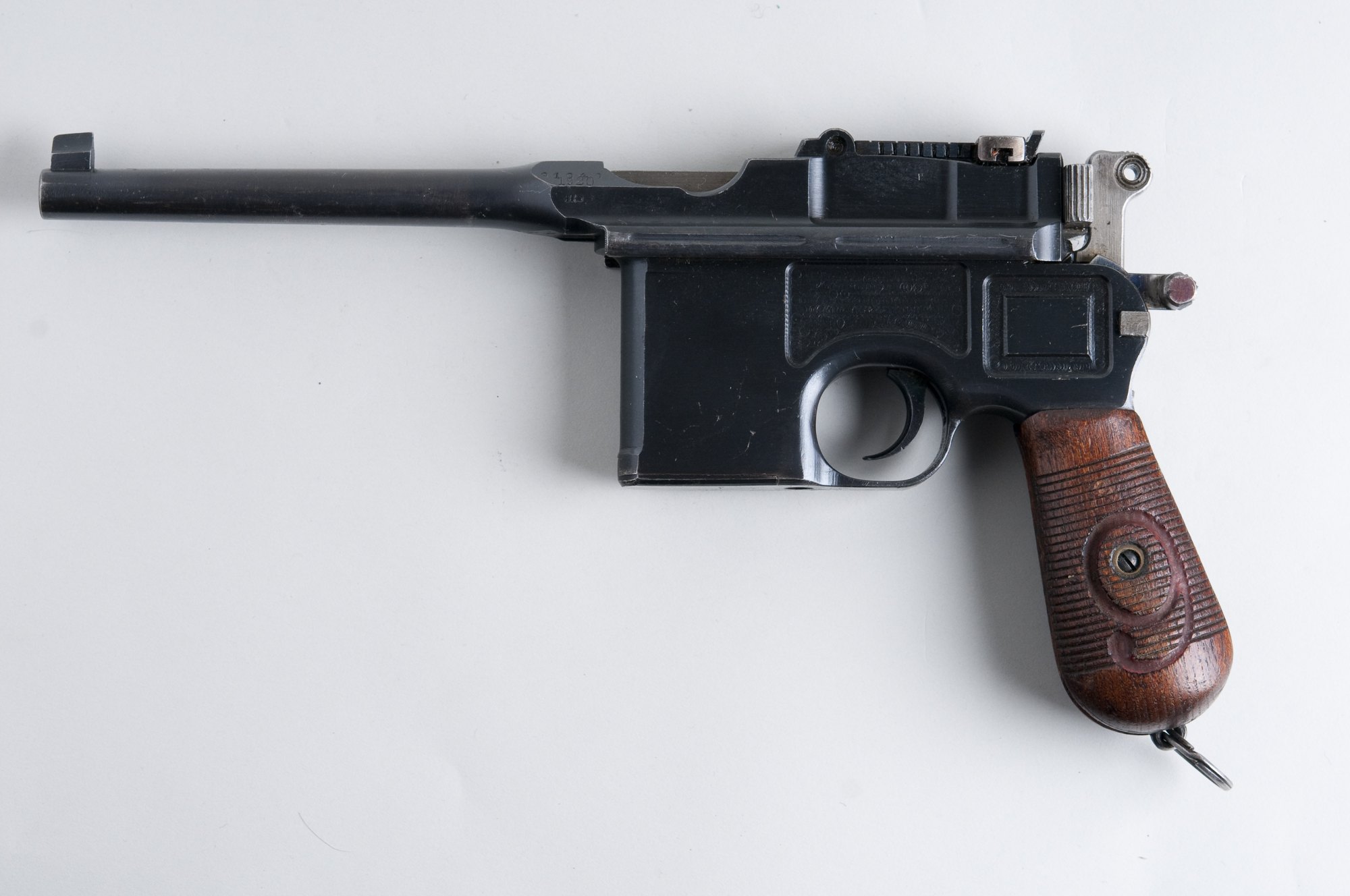 Mauser C96 Red 9 in 9mm, left side, with a large numeral 9 carved into the walnut grip and painted red