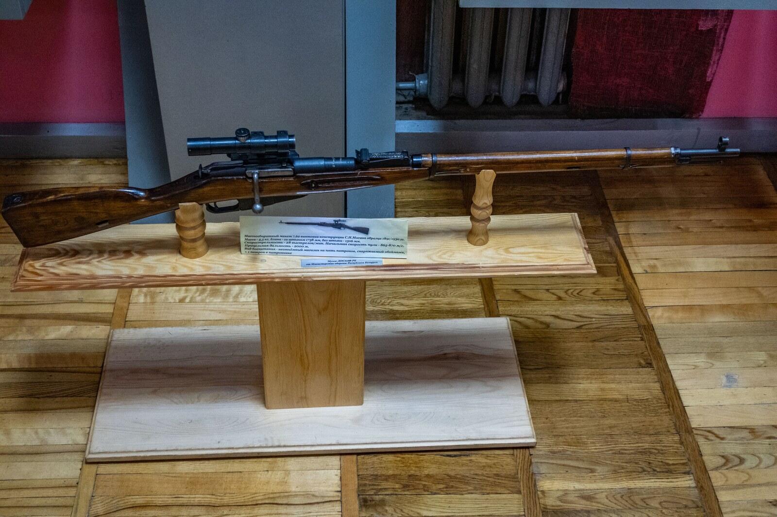 Soviet Mosin-Nagant sniper rifle with a telescopic sight on a museum display stand
