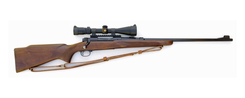 Pre-1964 Winchester Model 70 bolt-action rifle with scope and sling