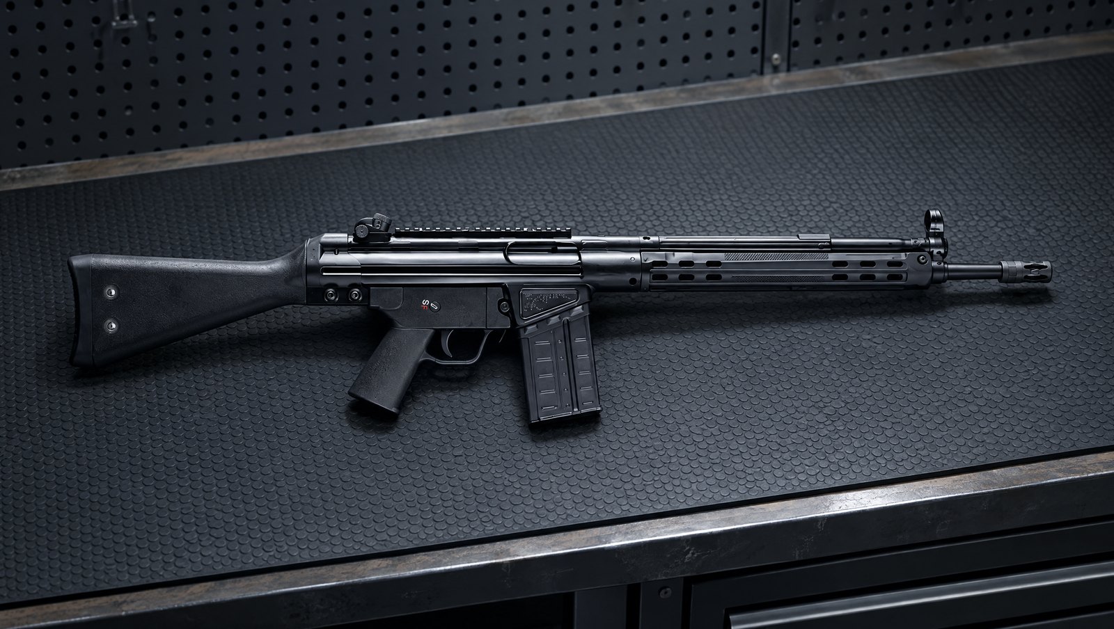 All-black PTR A3SK .308 rifle with welded top rail lying on a rubber bench mat