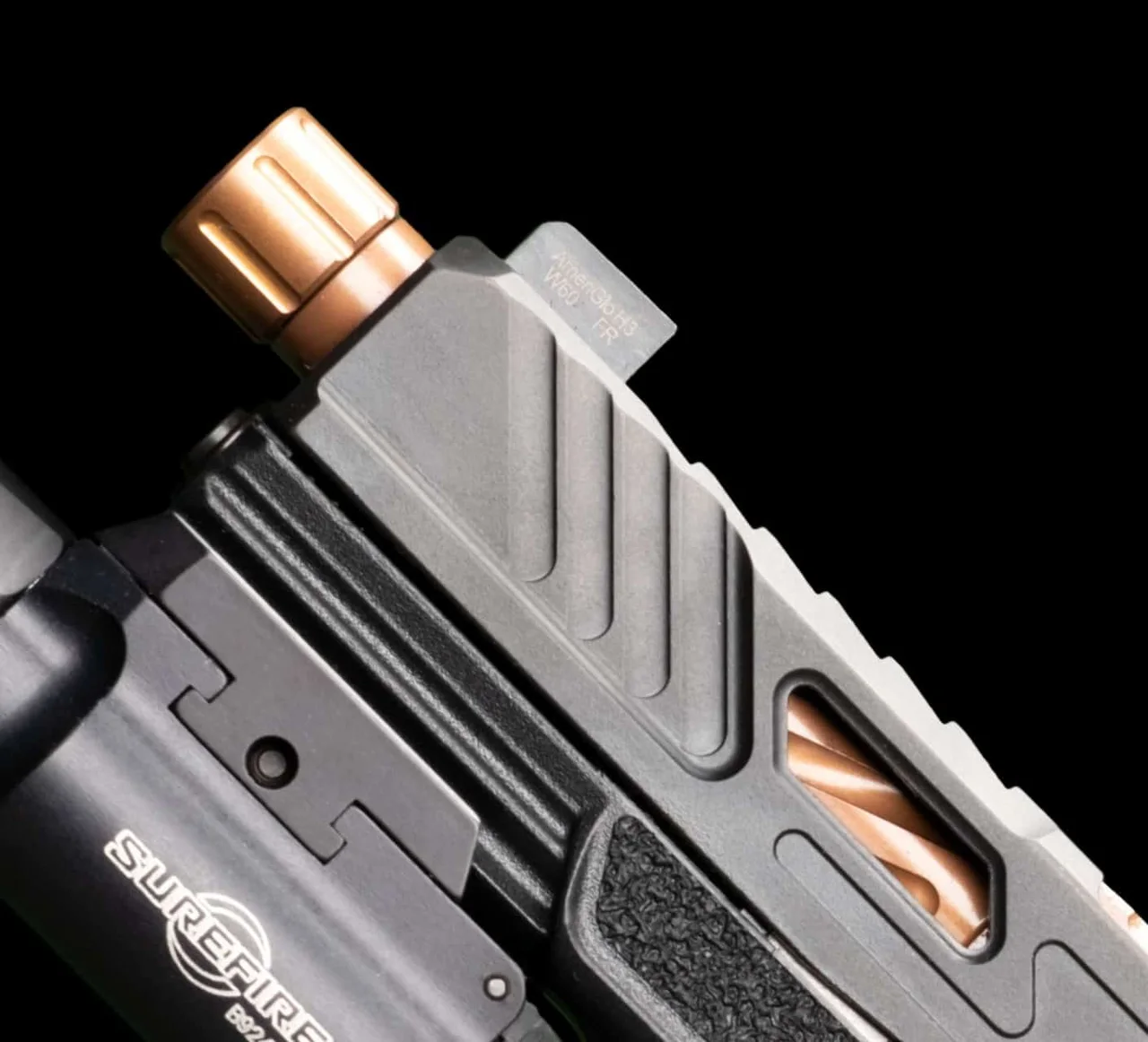Close-up of a Shadow Systems MR920 slide with a bronze threaded barrel, window cut and a SureFire weapon light