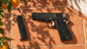 Spanish Star BM surplus pistol and magazine on terracotta tiles in a sunny courtyard