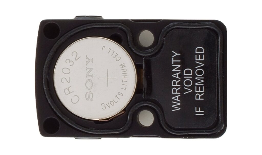 Underside of a Trijicon RMR showing the CR2032 battery that sits under the sight