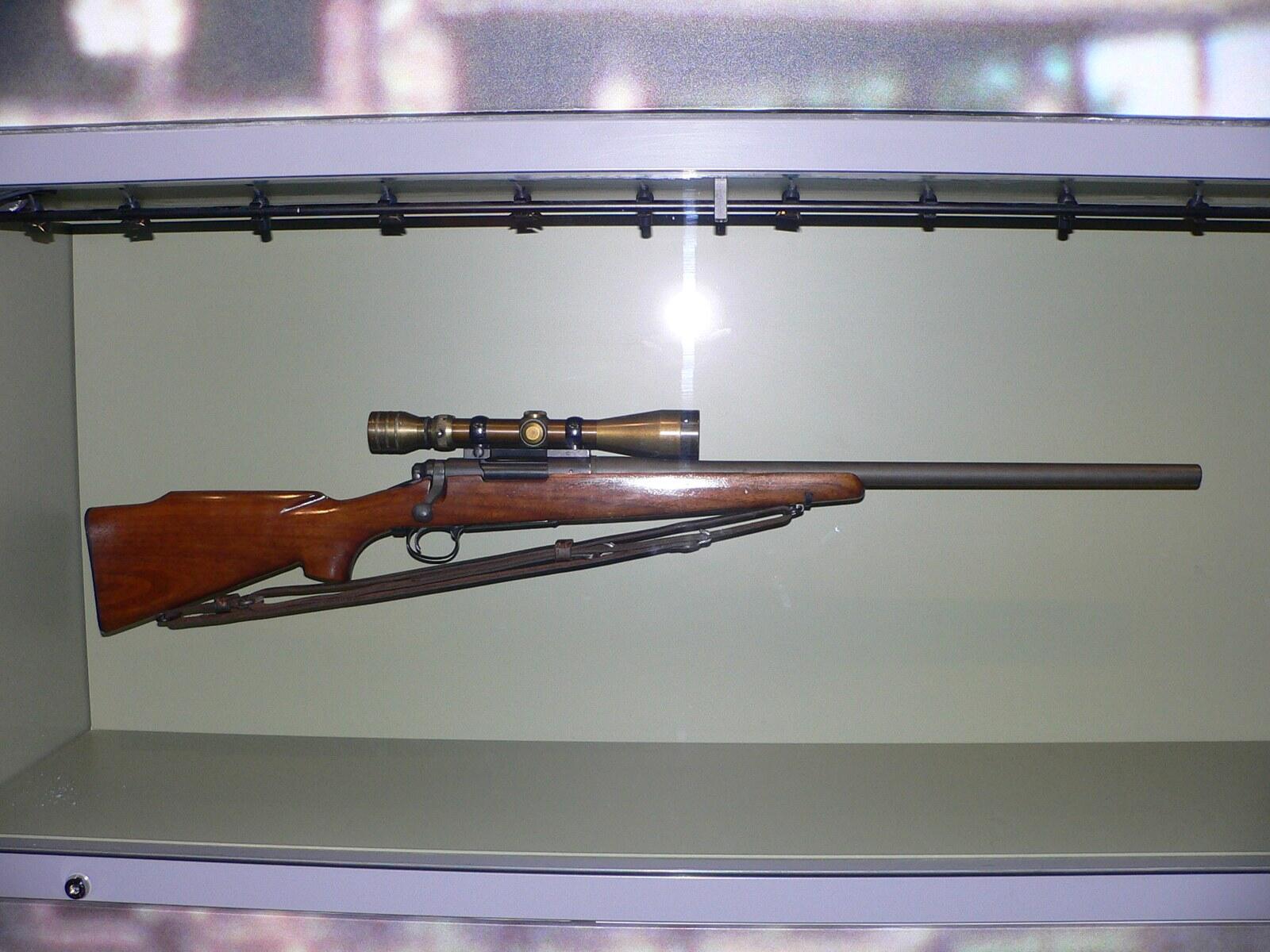 Chuck Mawhinney's Vietnam-era USMC M40 sniper rifle with a walnut stock and scope, on display at the National Museum of the Marine Corps