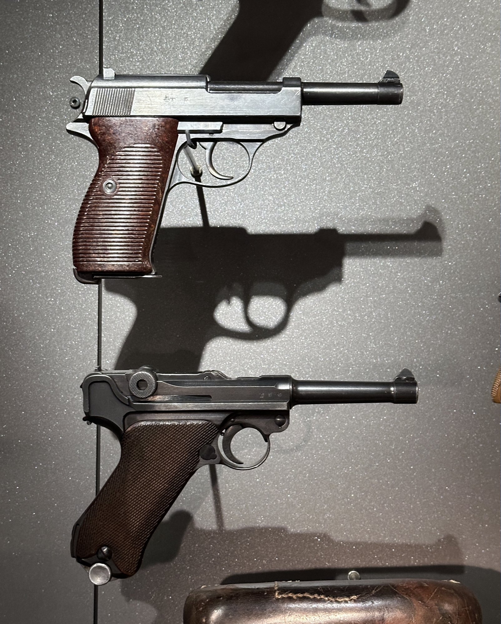 Walther P38 displayed above a P08 Luger, the pistol it replaced as the German service sidearm