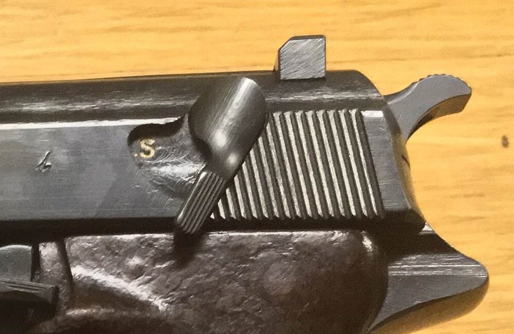 Walther P38 slide-mounted safety lever rotated down to the S safe position, with the hammer down