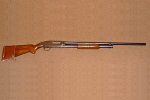 Winchester Model 12 pump shotgun made in 1948 with a long plain barrel and walnut stock