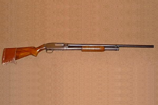Winchester Model 12 pump shotgun made in 1948 with a long plain barrel and walnut stock