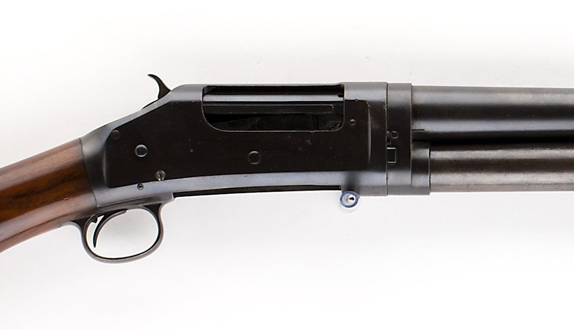 Exposed hammer and right side ejection port on the receiver of a Winchester Model 1897 shotgun