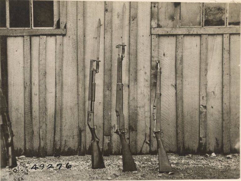 Winchester Model 1897 trench gun with bayonet fixed beside two Army rifles at AEF ordnance headquarters in France, 1919