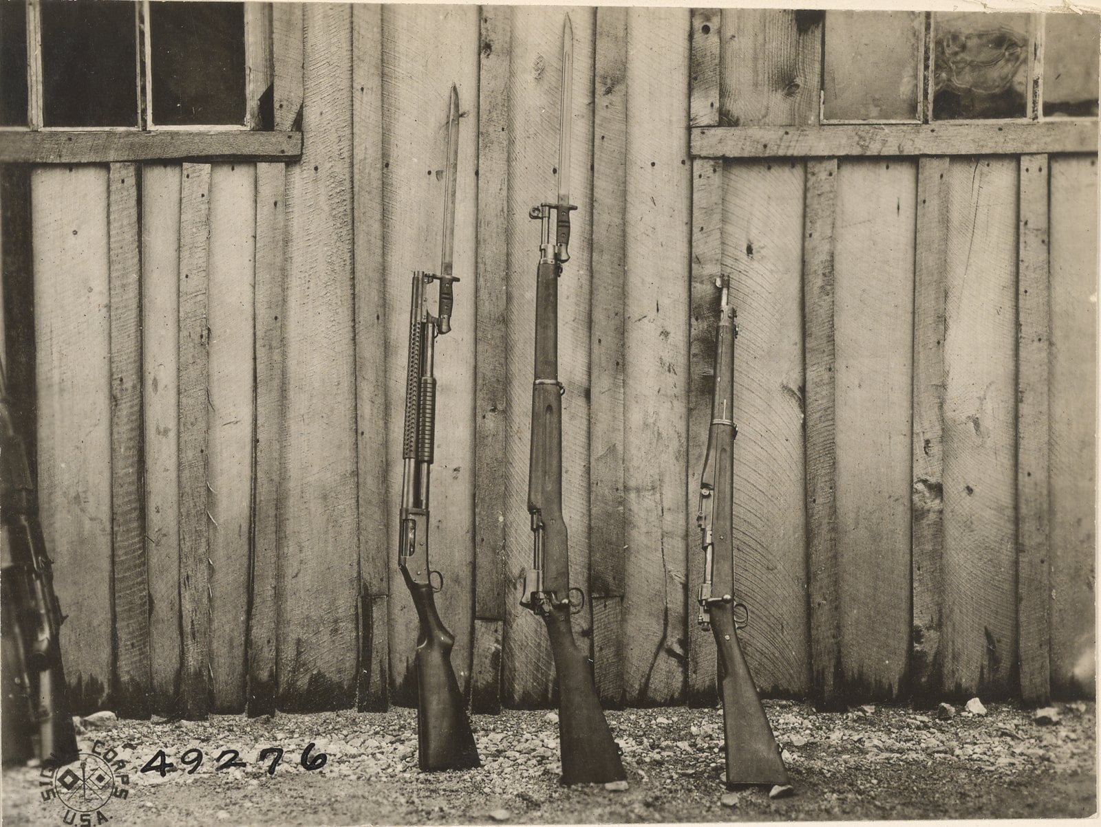 Winchester Model 1897 trench gun with bayonet fixed beside two Army rifles at AEF ordnance headquarters in France, 1919