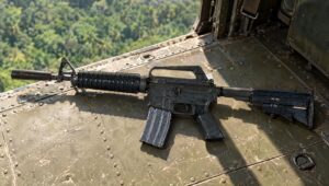 Colt XM177 carbine with a collapsible stock on the floor of a helicopter cabin over the jungle