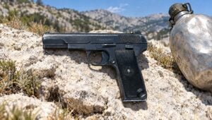 Yugoslav Zastava M57 Tokarev surplus pistol on a limestone rock in the Balkan mountains