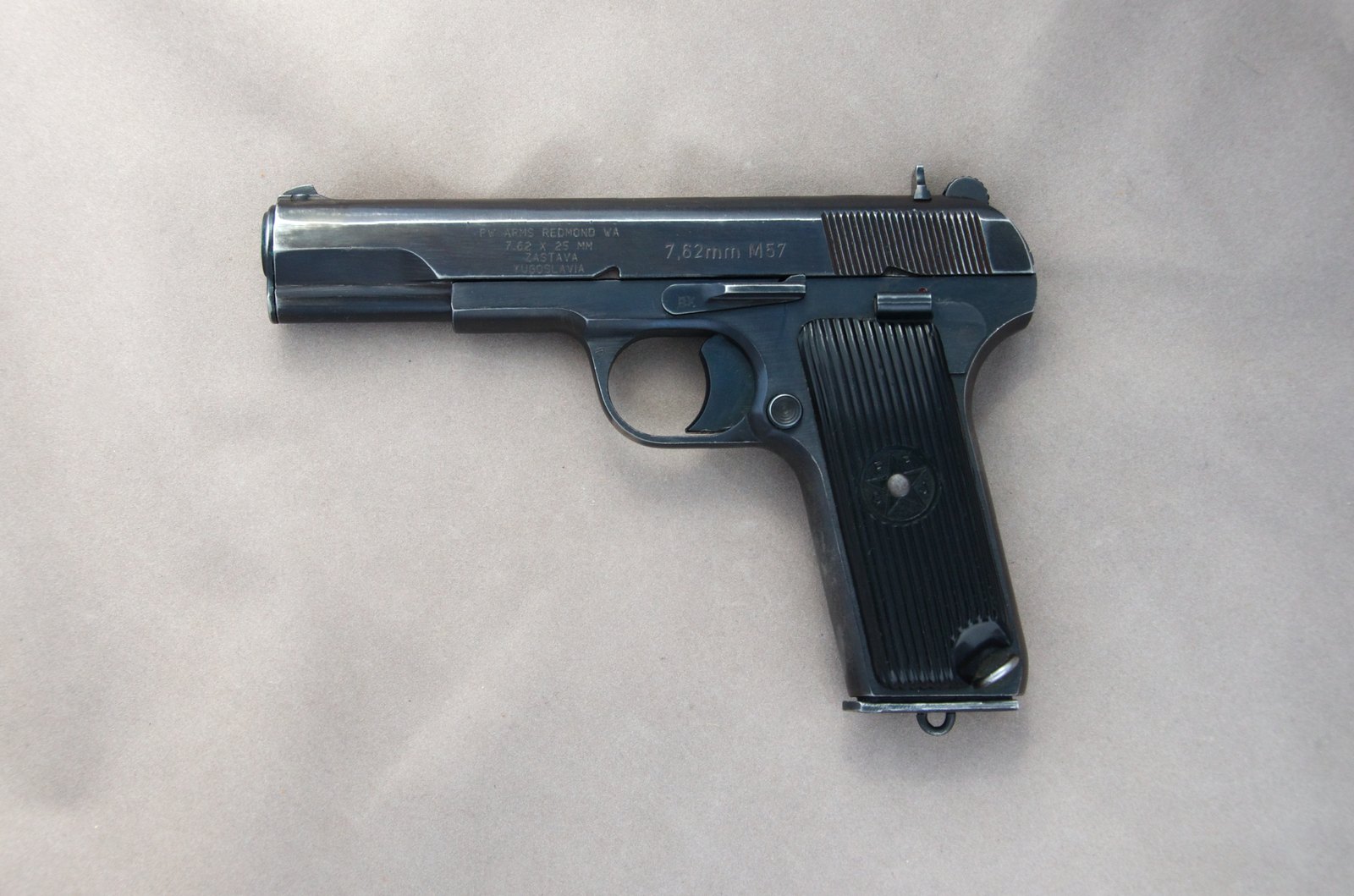 Left side of a 1964 Yugoslav Zastava M57 Tokarev pistol in 7.62x25 with its longer grip and import marks