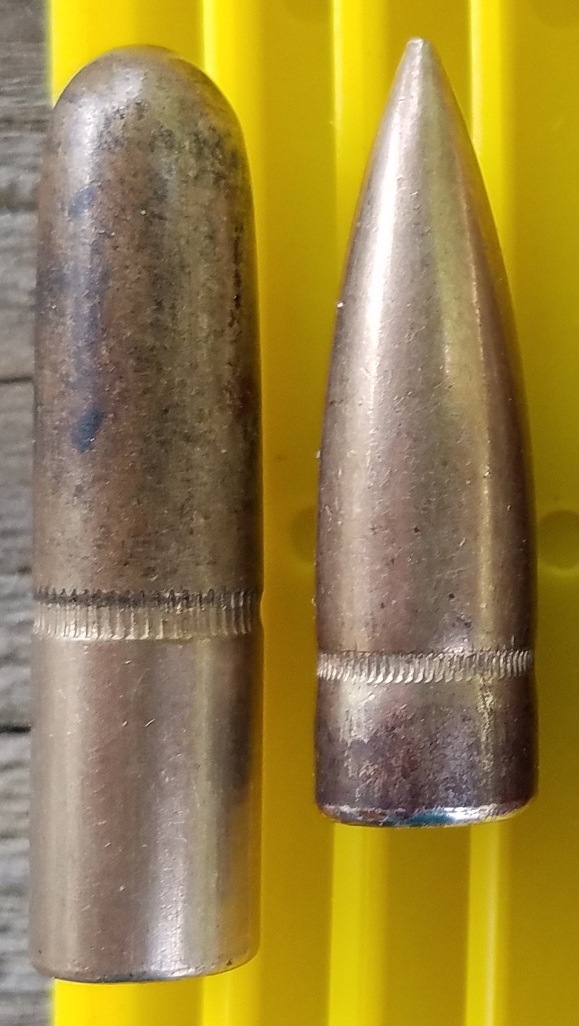 A 220-grain round-nose rifle bullet beside a 150-grain pointed spitzer bullet