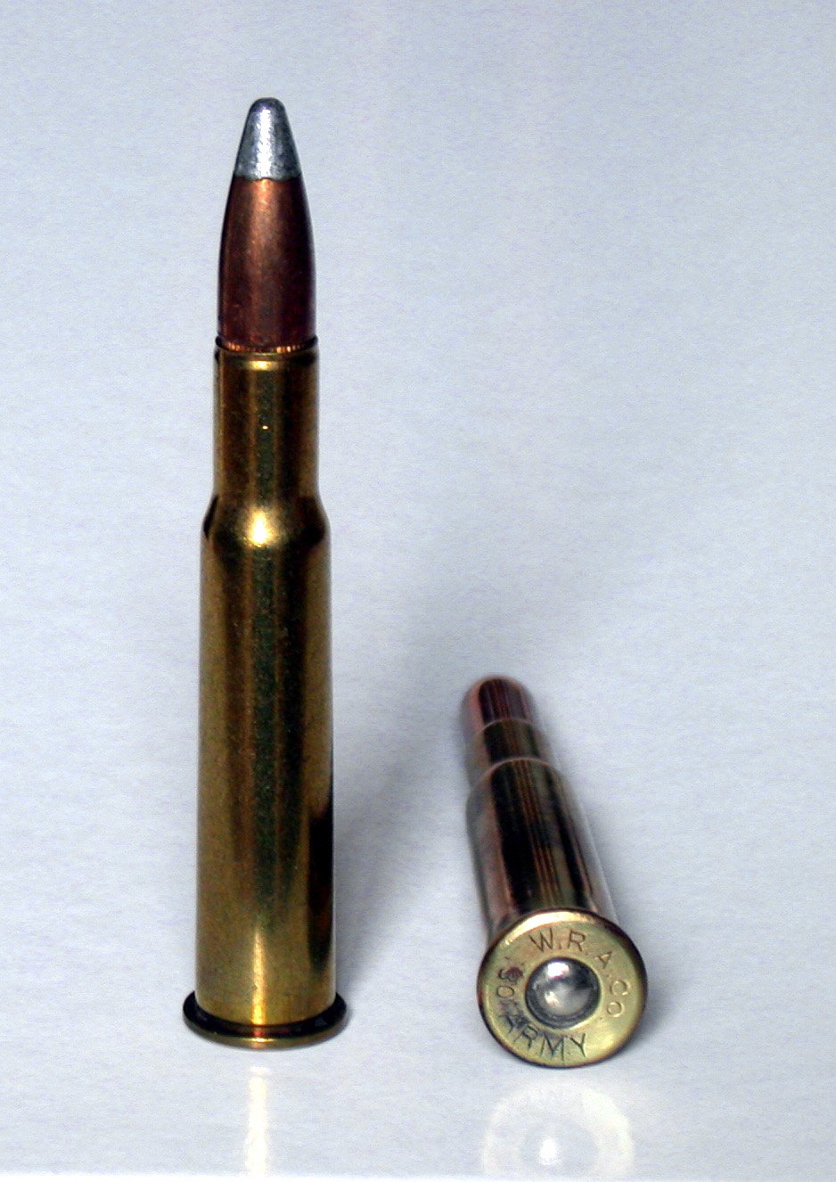 30-40 Krag cartridge standing beside a case head stamped W.R.A. Co. 30 Army
