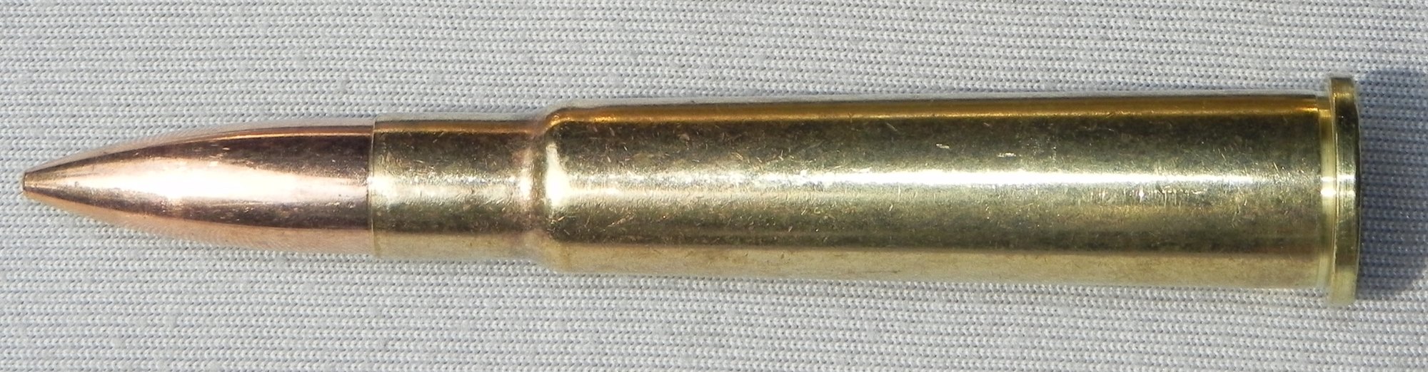 303 British cartridge lying in profile with its rim visible