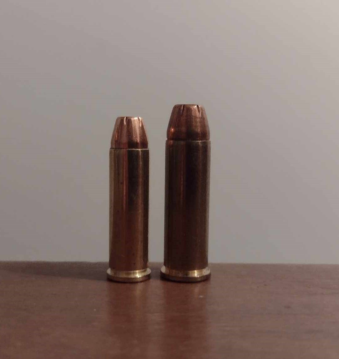 32 H&R Magnum hollow point cartridge beside a 38 Special hollow point