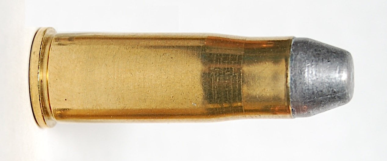 38-40 Winchester cartridge with a lead flat-nose bullet on white