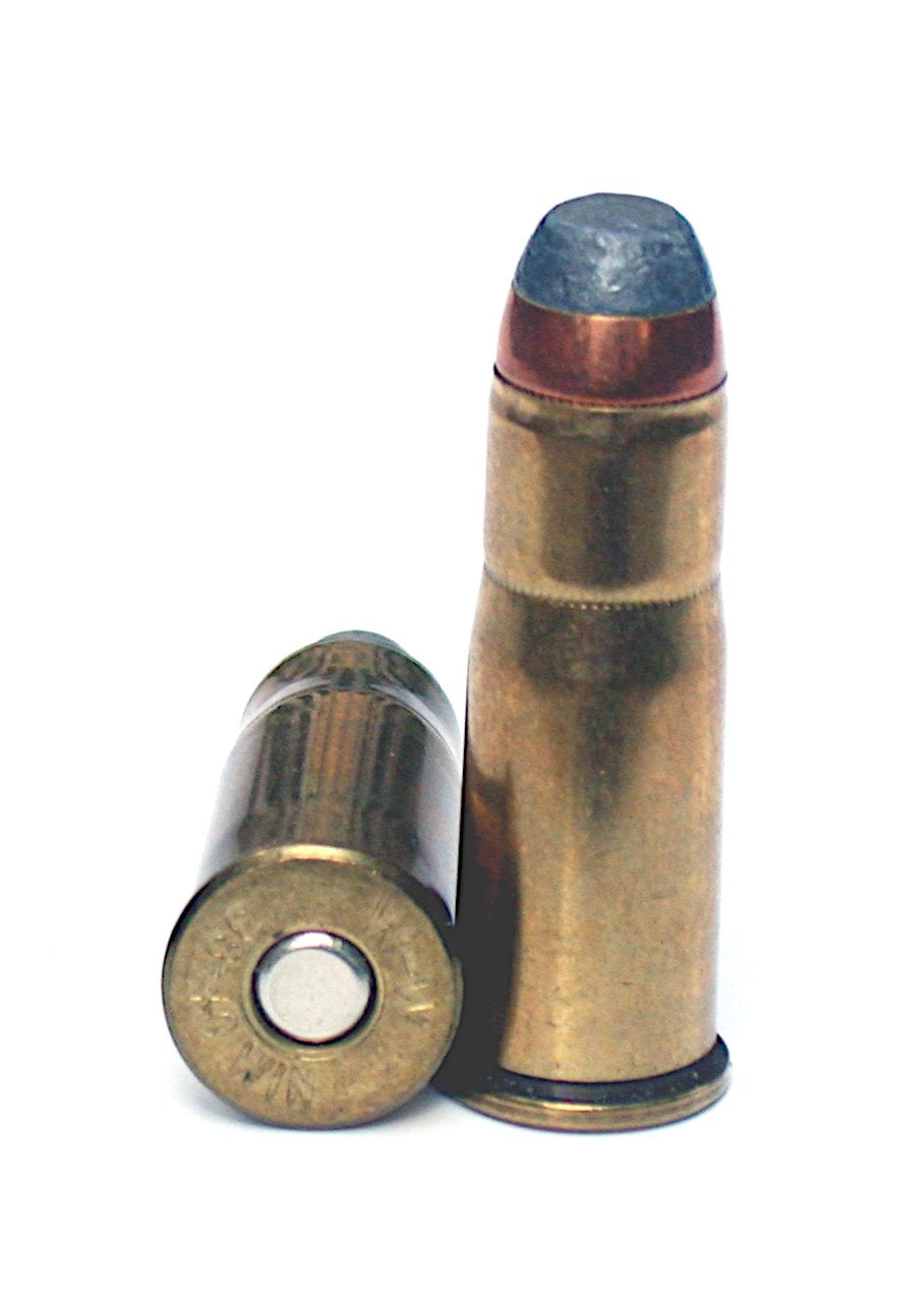 Two 38-40 Winchester cartridges, one standing and one showing its base