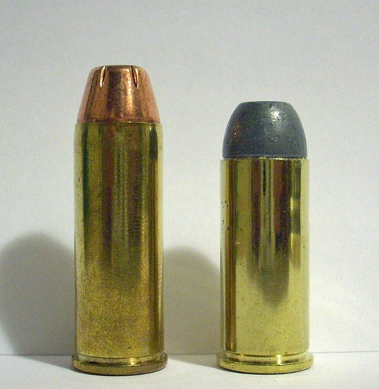 45 Colt cartridge standing beside a shorter 45 Schofield cartridge