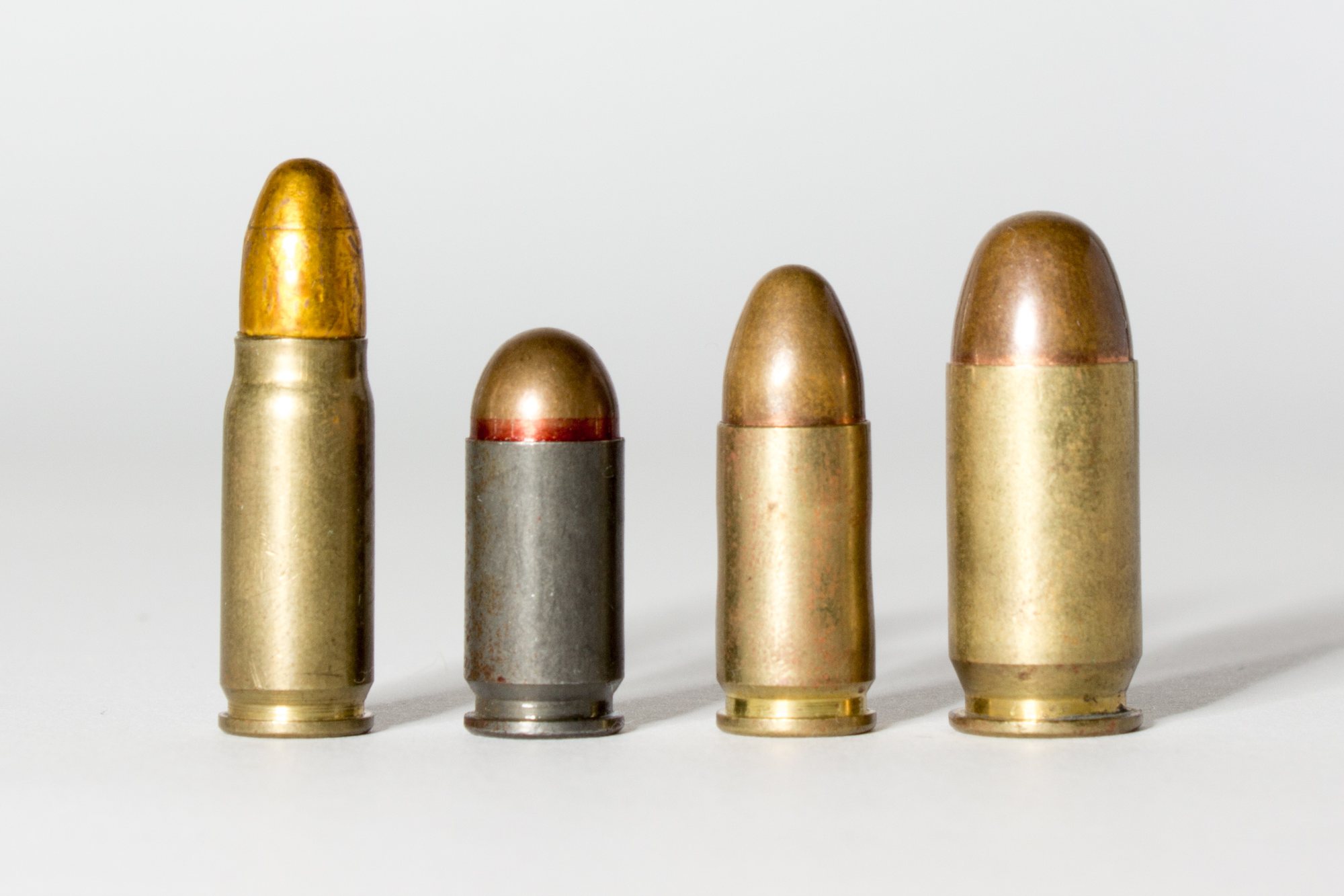 7.62x25 Tokarev cartridge standing beside 9x18 Makarov, 9mm Luger and .45 ACP cartridges