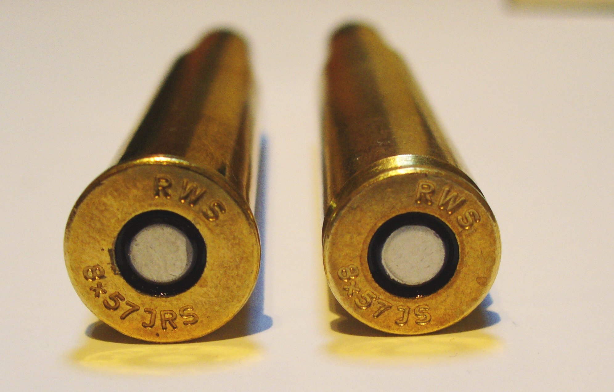 Two RWS cartridge headstamps, a rimmed 8x57 JRS on the left and a rimless 8x57 JS on the right
