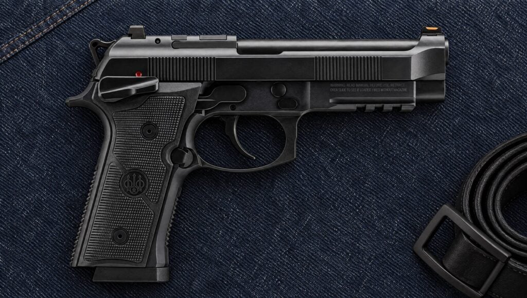 Beretta 92GTS Full Size in black with frame-mounted decocker and skeletonized hammer lying flat on indigo denim