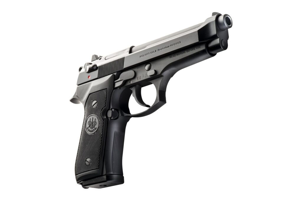 Beretta 92FS seen from the front right, showing the open-top slide, the exposed barrel and a frame with no accessory rail
