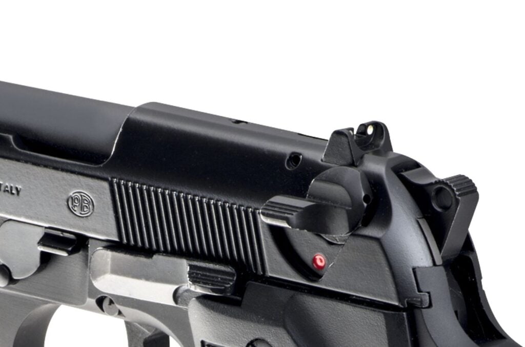 Beretta 92FS close-up of the slide-mounted safety lever, hammer, rear sight and slide serrations