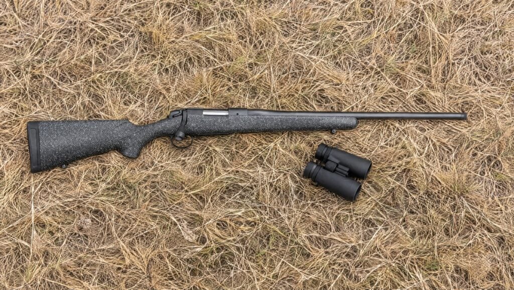Bergara B-14 Ridge with gray speckled synthetic stock and No. 5 taper barrel lying flat on dry prairie grass