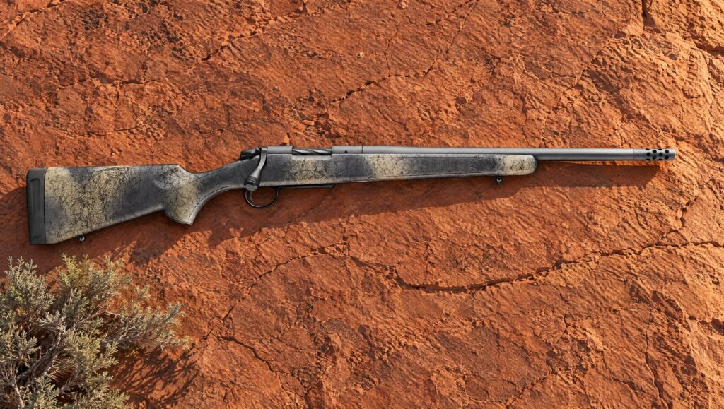 Bergara B-14 Wilderness Ridge with camo stock, Sniper Grey Cerakote barrel and Omni muzzle brake lying flat on red sandstone
