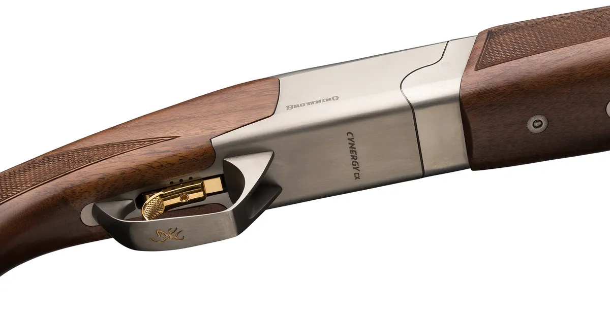 Underside of the Browning Cynergy CX receiver marked Cynergy CX, with the gold trigger, silver nitride finish and checkered walnut, Browning photo