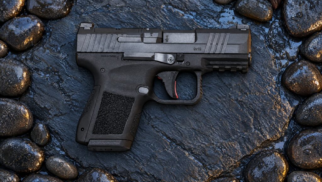 Black Canik METE MC9 pistol lying on a wet slate stone among dark river pebbles at blue hour