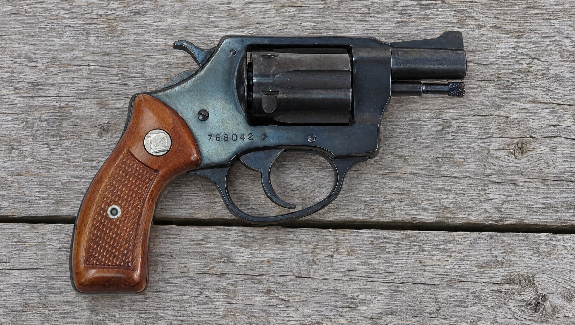 Blued Charter Arms Undercover 32 snub nose revolver on weathered gray boards