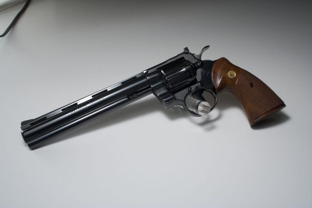 A Colt Python Target revolver with an eight inch vent rib barrel, blue finish and walnut grips with gold Colt medallions