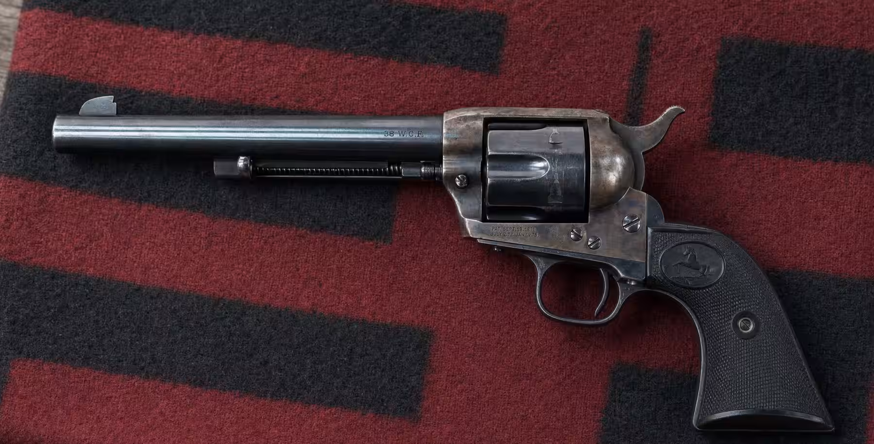 Blued Colt Single Action Army revolver in 38-40 on a red and black wool blanket