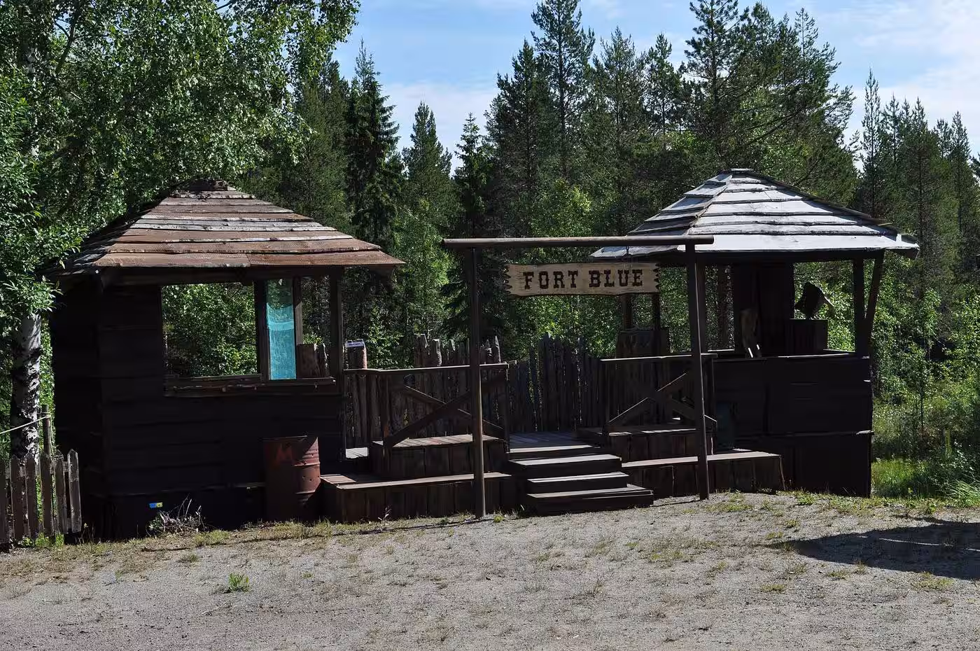 Wooden western stage props with a Fort Blue sign at a cowboy action shooting match