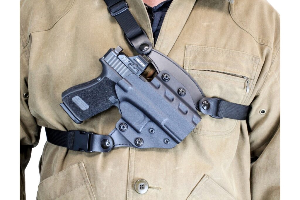 DeSantis Outdraw Kydex chest rig carrying a pistol with a red dot over a field jacket
