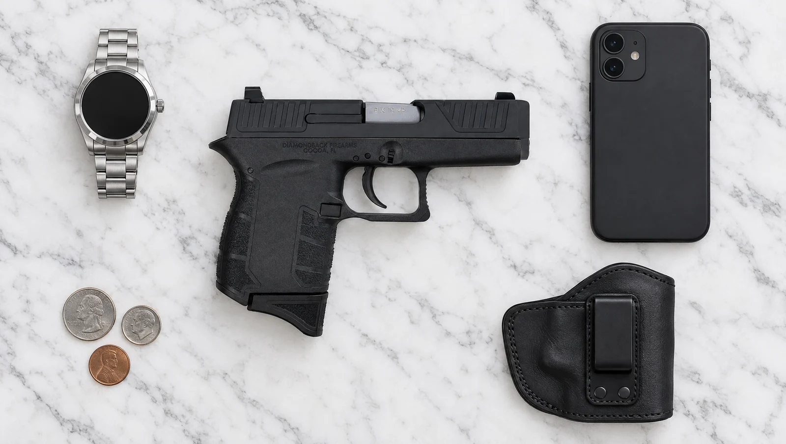 Right side of a Diamondback DB9 Gen 4 9mm lying flat on a marble dresser beside a watch, a phone, coins and a leather IWB holster