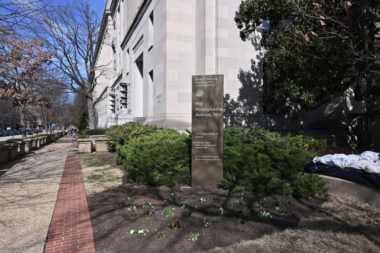 Sign outside the Robert F. Kennedy Department of Justice Building in Washington, DC, where DOJ is based