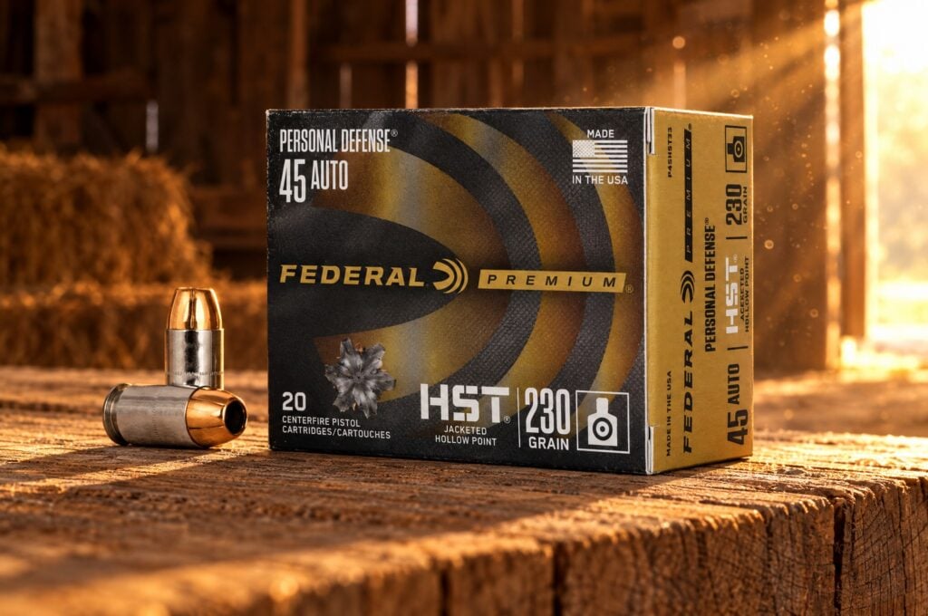 Personal Defense HST 45 Auto 230 grain box and two cartridges on an oak plank in a barn at golden hour