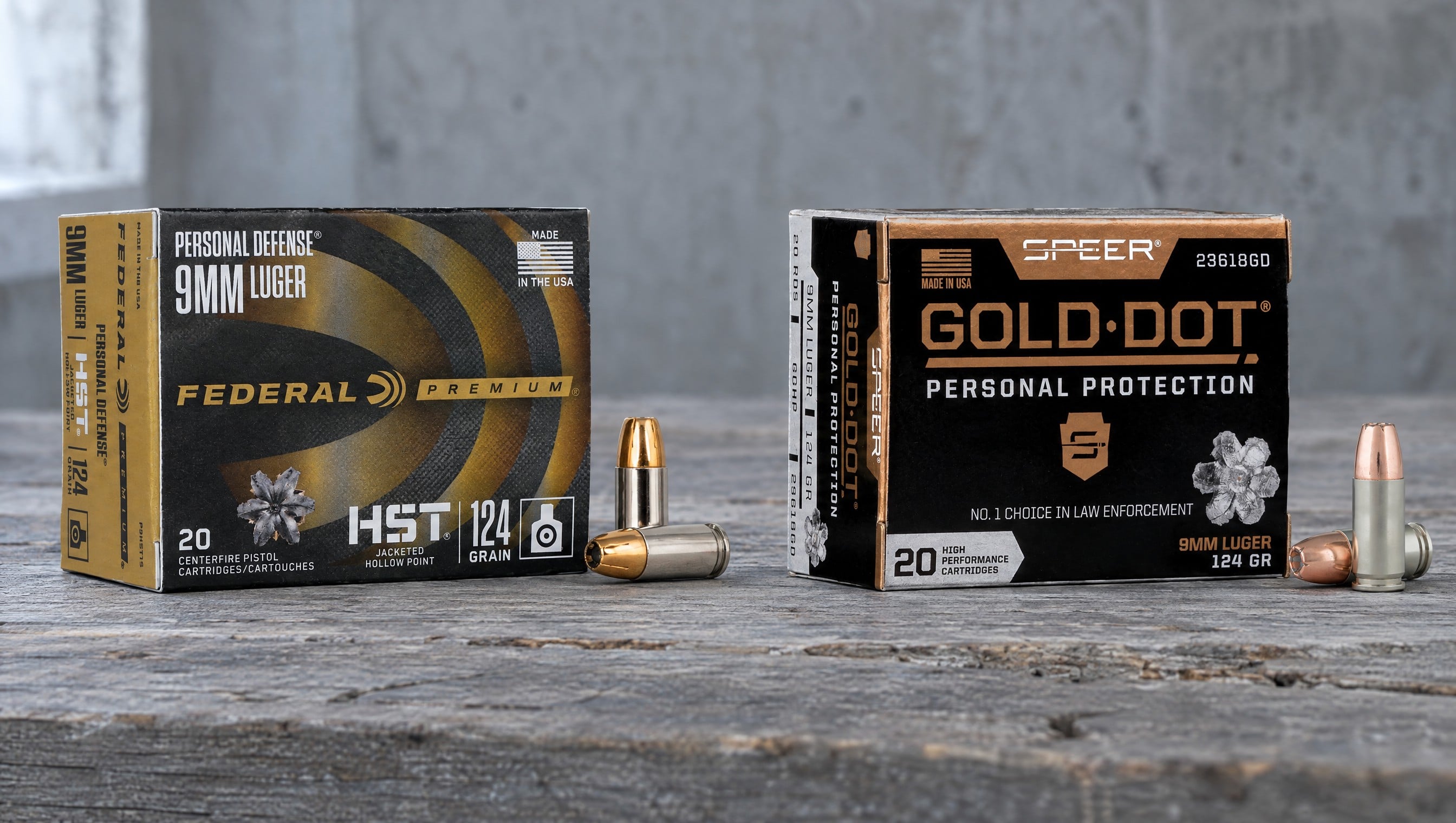 Federal HST vs Speer Gold Dot: HST 9mm Luger 124 grain and Gold Dot 9mm Luger 124 GR boxes with two cartridges each on a barnwood bench