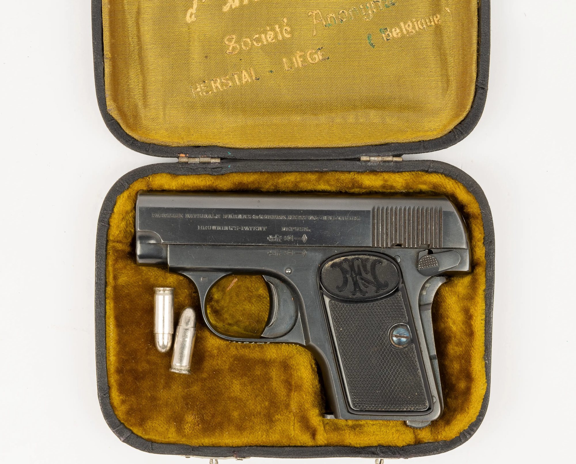 FN Browning 1906 pistol in its fitted case with two 6.35 mm cartridges